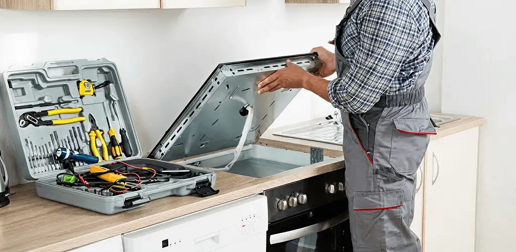 Handyman repairing a cooktop and checking wiring connections in Orlando, FL