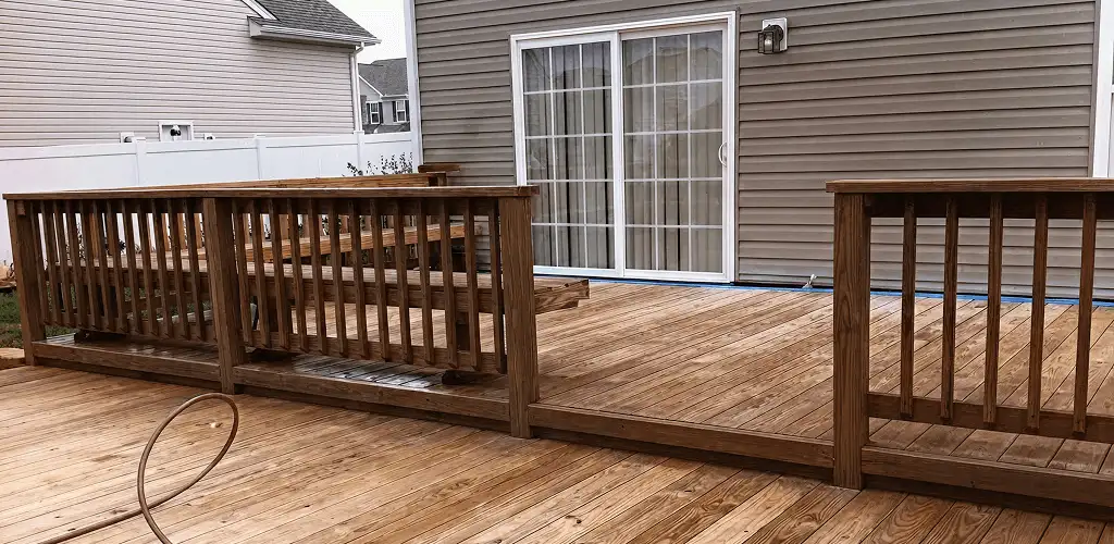 Deck sealing service protecting a backyard wood deck and railings in Orlando, FL