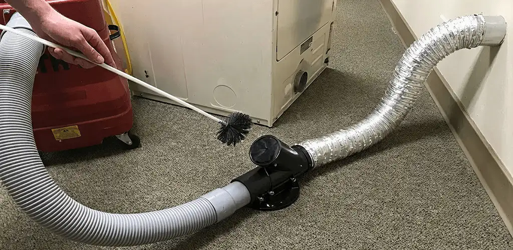Dryer vent cleaning service removing lint from a dryer duct connection in Orlando, FL