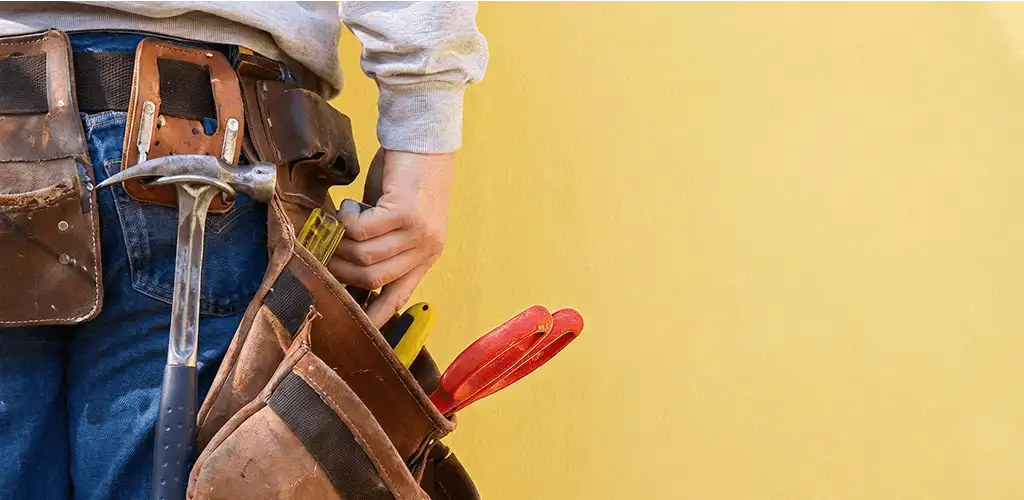 Handyman with tool belt ready for home repairs and maintenance in Orlando, FL