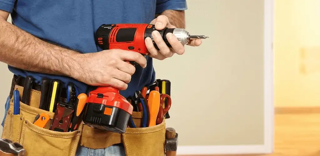 Handyman holding a power drill for home repairs and installations in Orlando, FL