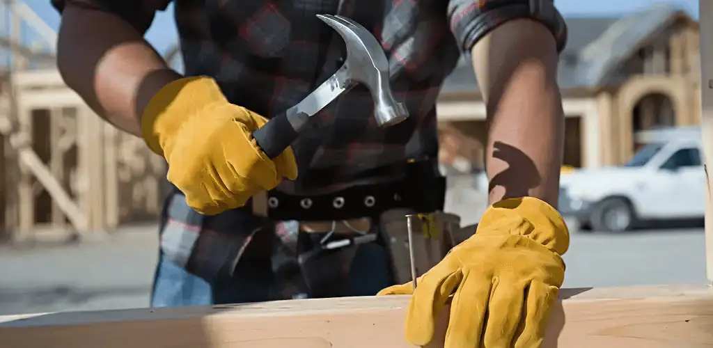 Handyman fixing wood trim with a hammer for home repairs in Orlando, FL