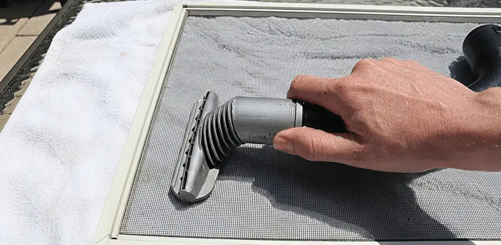 Window screen repair cleaning and fixing a damaged screen mesh in Orlando, FL